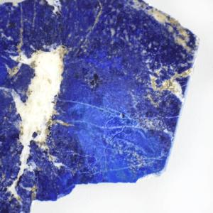 Ein roher Lapislazuli Stein. Titelbild für einen Blogbeitrag über die Wirkung & Eigenschaften von Lapislazuli.